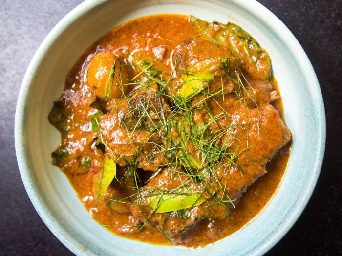 An overhead closeup shot of an individual serving of beef short rib Panang curry.