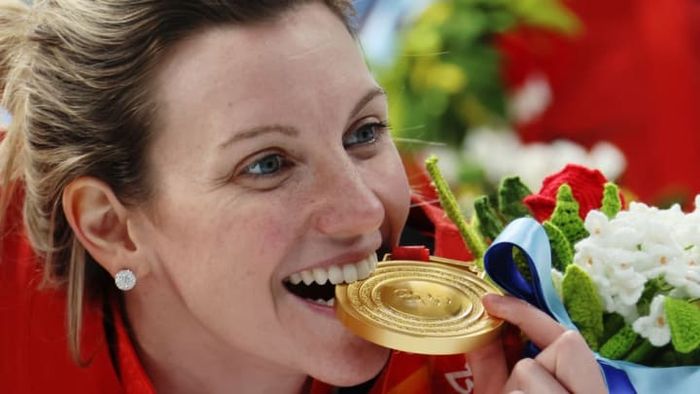 After Team Canada's victory in the Women's Ice Hockey Gold Medal match against Team United States at the Beijing 2022 Winter Olympics, Laura Stacey took a bite of her gold medal.