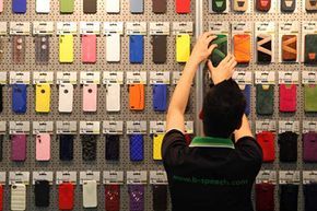 A worker arranges Apple iPhone cases