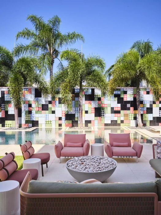 backyard patio adjacent to a pool