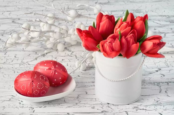 Red tulips and red Easter eggs as part of a holiday centerpiece