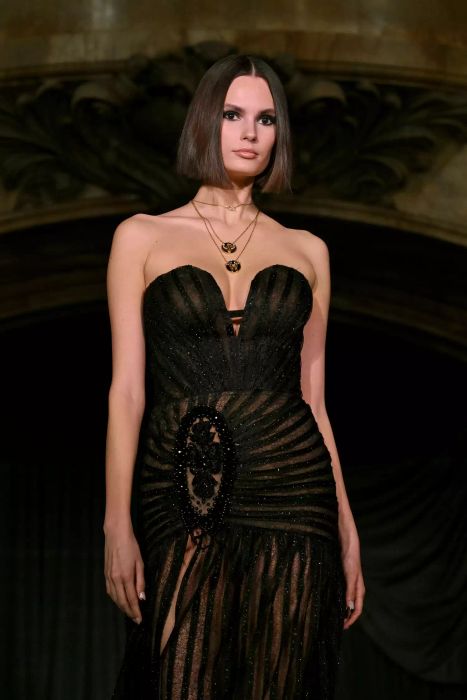 A model at New York Fashion Week showcases a smokey eye look paired with a black strapless dress at PatBo’s runway show.