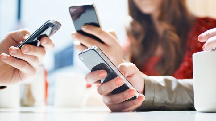 Three individuals using various WiFi-enabled phones.