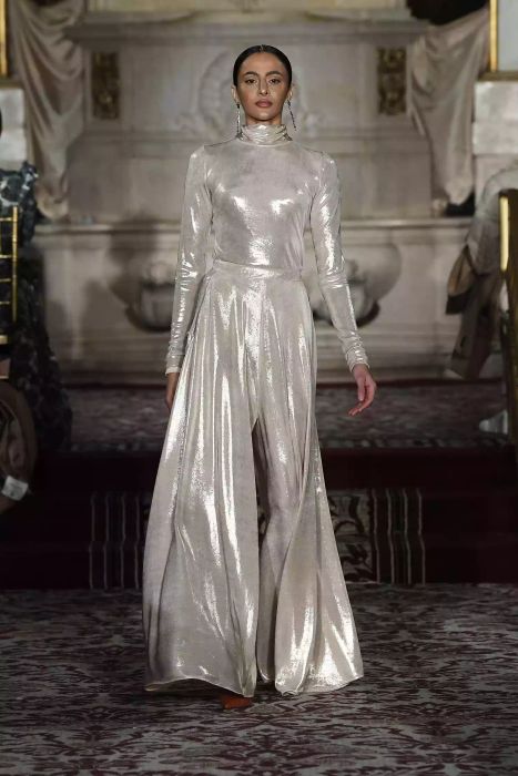A model at Christian Siriano’s runway show rocks a monochromatic metallic color ensemble.