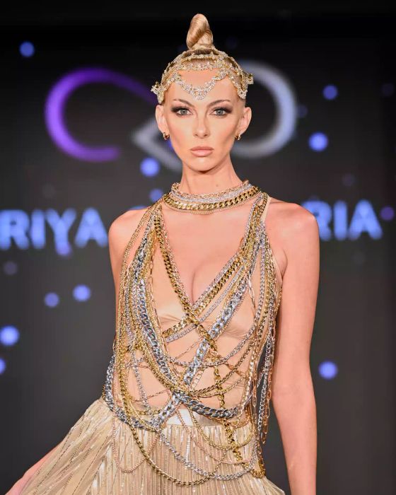 A model graces the Priya Chhabria runway wearing a sparkling embellished hairpiece and a stunning dress.