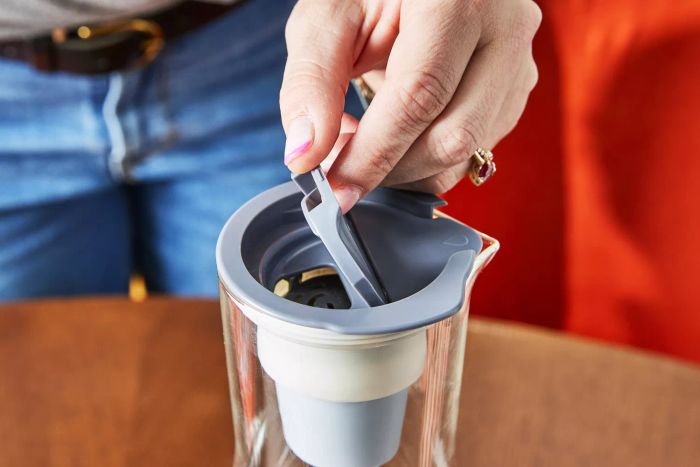 A hand opening the Hydros pitcher