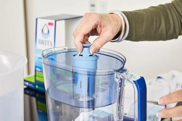 A person inserts a filter into the Brita Tahoe Water Pitcher with Elite Filter