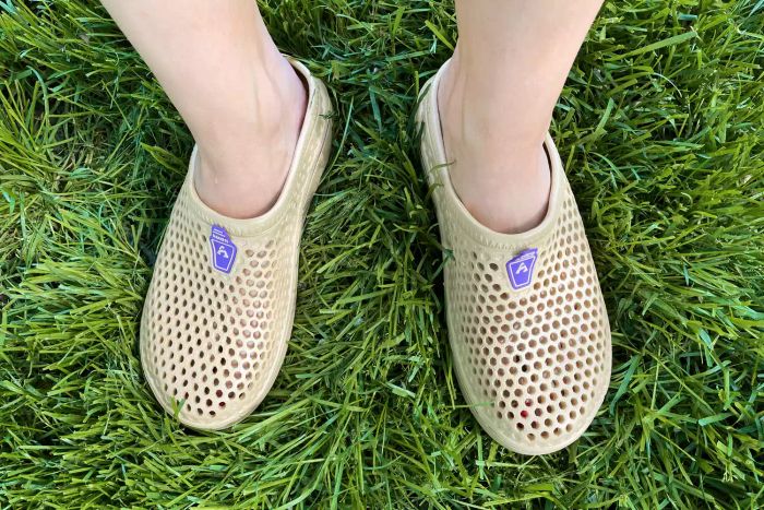 Person wearing Amoji Garden Clogs while standing on grass