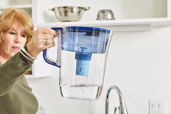 A person lifts the Brita Tahoe Water Pitcher equipped with the Elite Filter