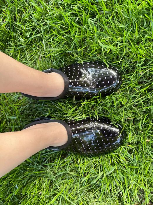 Person wearing Sloggers Rain & Garden Shoes while standing on grass