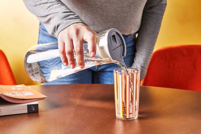 Hydros pouring water from the pitcher into a glass