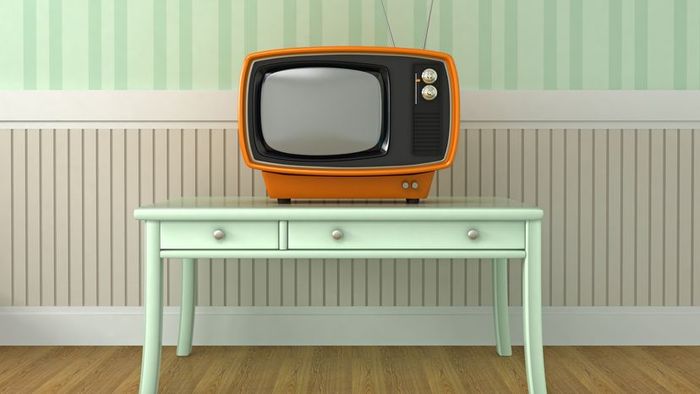 A vintage-style television resting on a small table.