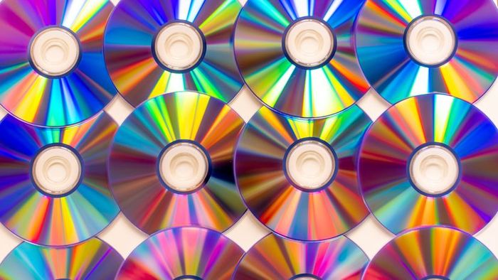 A setup of CD and DVD surfaces reflecting light.