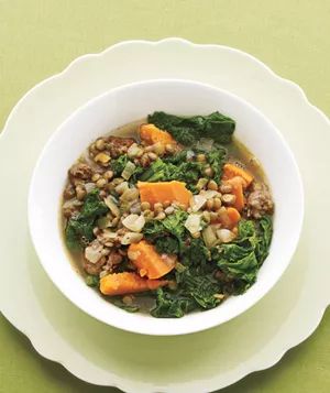 A hearty stew featuring lentils, mustard greens, and sausage