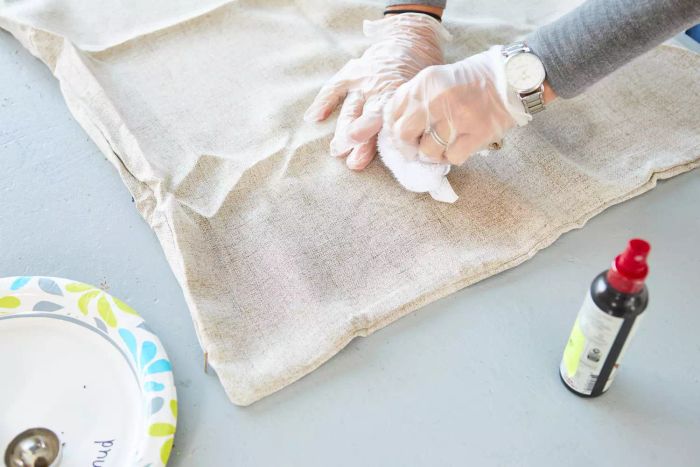 A person removing a stain from a pillowcase using Emergency Stain Rescue Chateau Spill Red Wine Stain Remover.