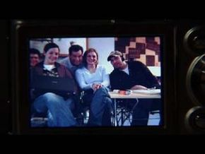 A picture of a group of individuals is displayed on a digital camera's LCD screen.