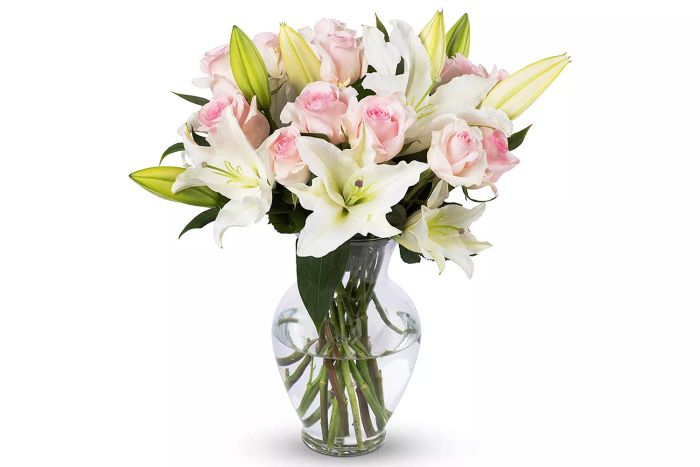 Benchmark Bouquets offers a beautiful arrangement of pink roses and white lilies, perfect for any occasion.