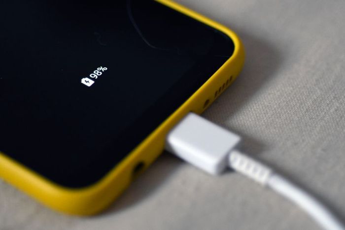 Cell phone charging at 98% battery level while plugged in
