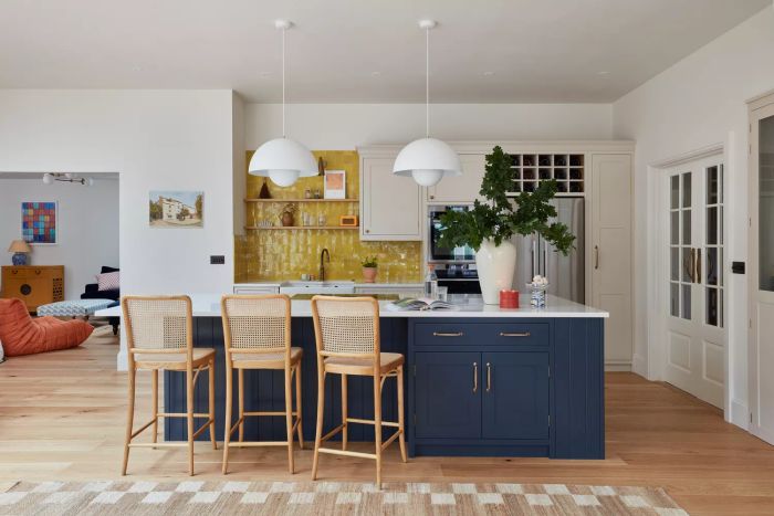 navy and white kitchen featuring a yellow-tiled backsplash