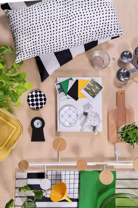 Aerial view of decor items on a table, pillows, small clock, and plants