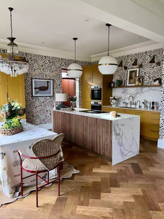 kitchen with patterned wallpaper and yellow cabinetry