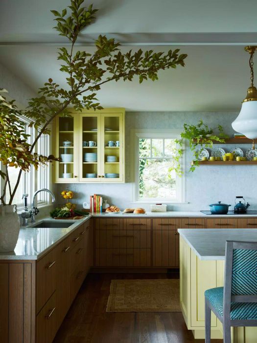 kitchen featuring warm wood lower cabinets and yellow upper cabinets