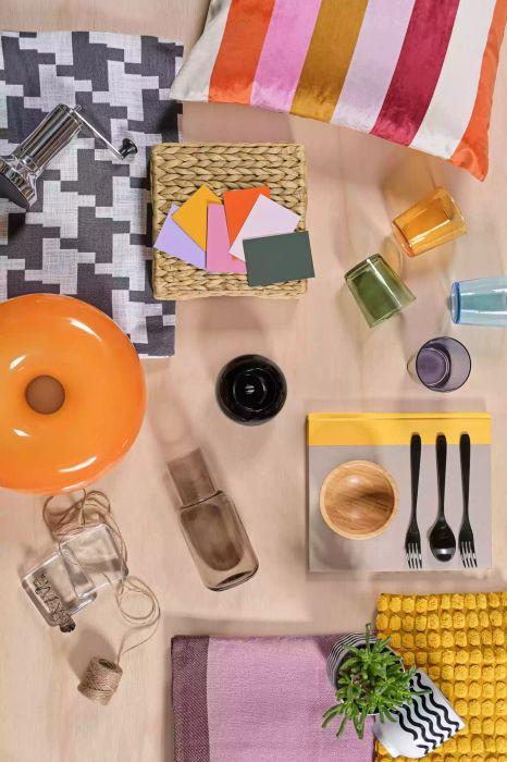 Overhead view of decor items, paint samples, and kitchen supplies