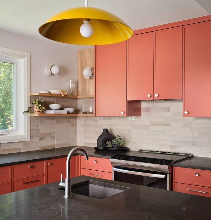kitchen with salmon-colored cabinets and yellow pendant light