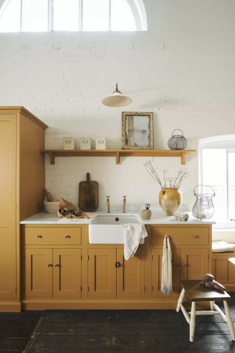 country cottage-style kitchen featuring yellow cabinetry