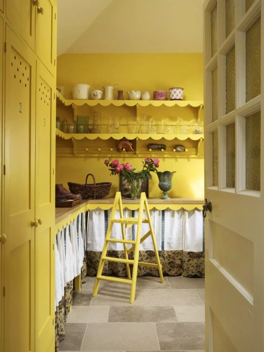 Bright yellow kitchen with scalloped shelves