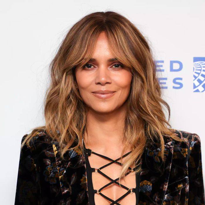 Halle Berry rocking tousled caramel waves and curtain bangs