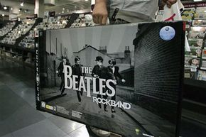 A person purchases The Beatles: Rock Band