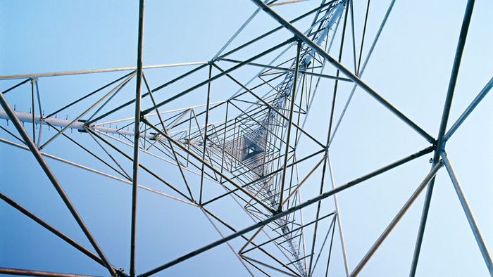 Worker Climbing Communication Tower