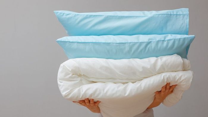 a woman holding pillows