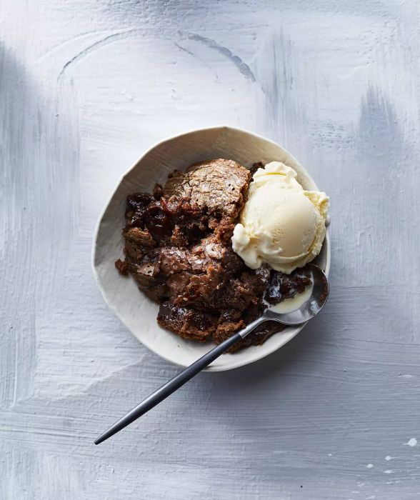Slow-Cooker Chocolate Pudding Cake served with a scoop of ice cream on the side.