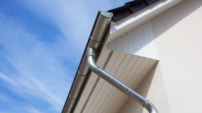 Eaves featuring gutters on a white house.