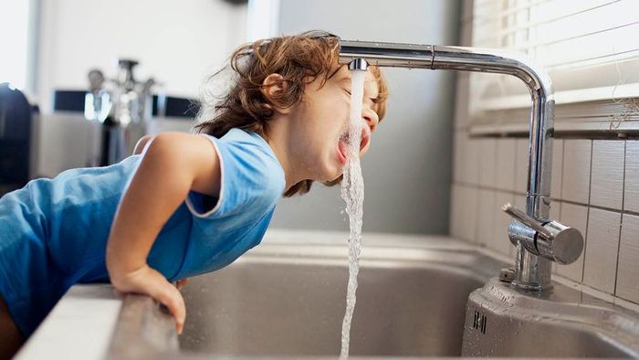 A child drinking a glass of water