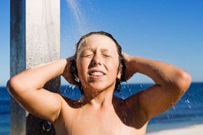 A young boy enjoying an outdoor shower.&nbsp;