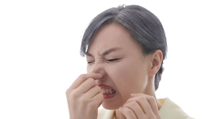 a woman pinching her nose