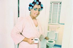 woman gesturing at a smelly toilet