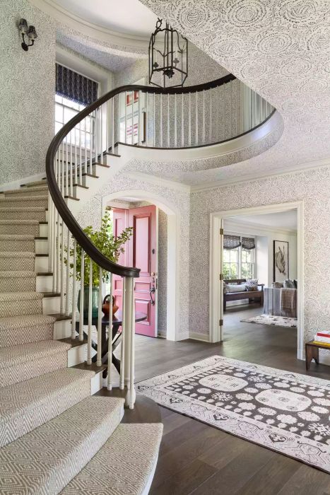 Curved staircase with wallpapered walls