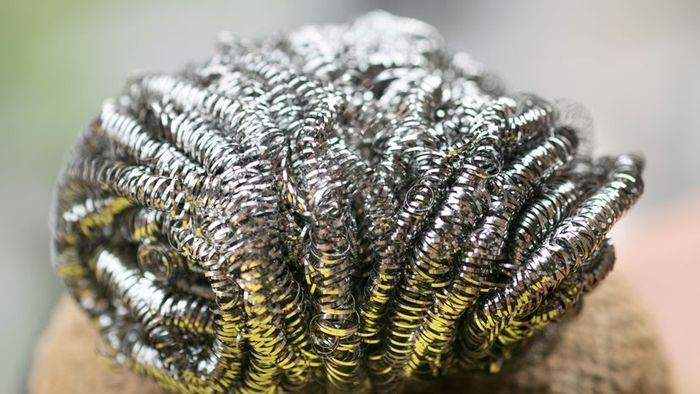 A close-up shot of a steel wool pad or metal sponge.