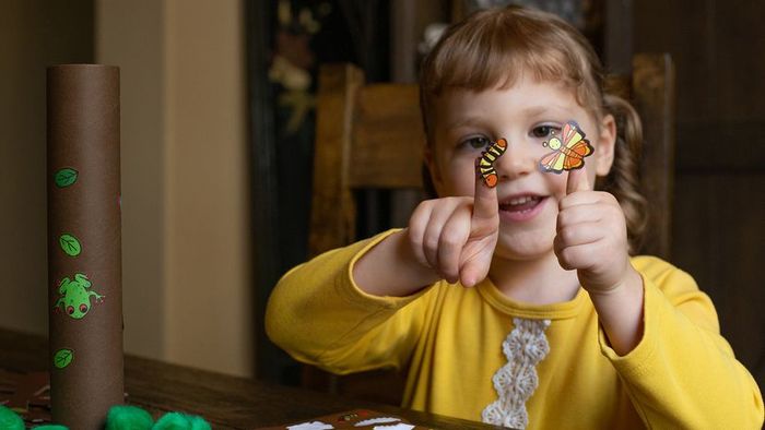 A young girl creating art with a tree project