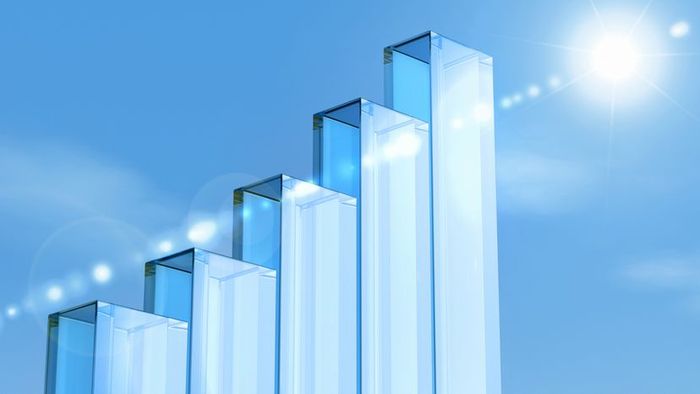 Glass-like pillars forming a bar graph set against a clear blue sky.