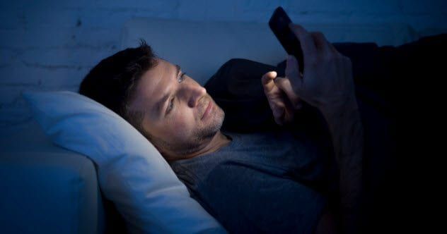 4a-using-smartphone-at-night-498174966