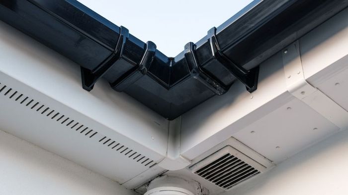 Vinyl vented soffit panels placed beneath the fascia of a house.