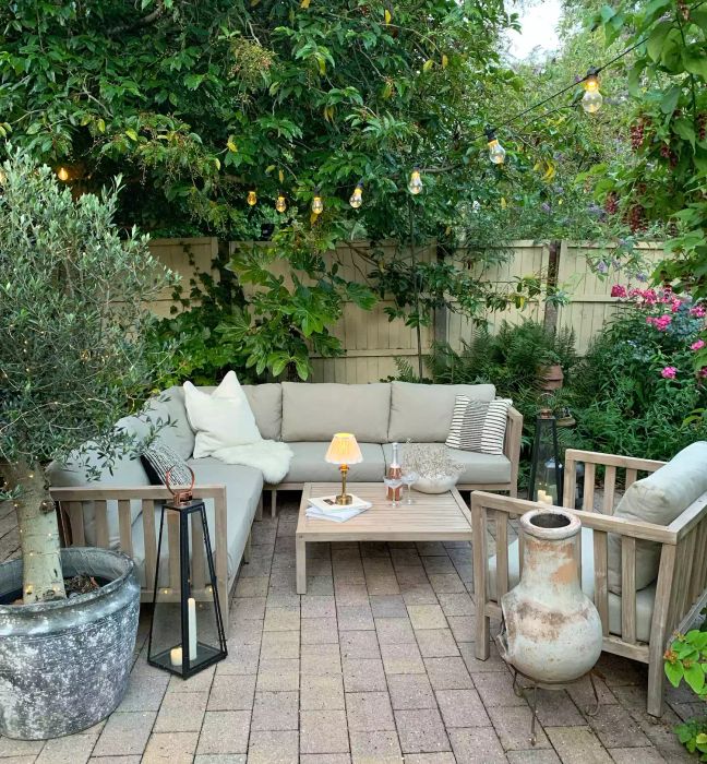 Backyard with string lights and a table lamp
