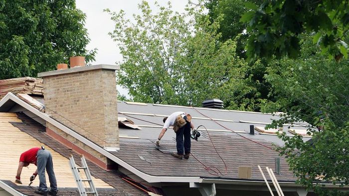 Men fixing a roof