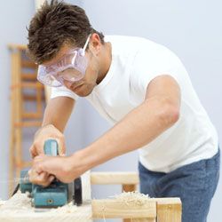 A person cutting wood with a saw