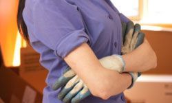 A woman wearing protective DIY gloves